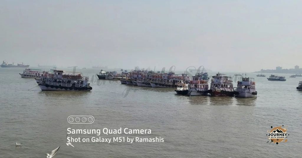 Passenger ferries and boats gathered along the waters leading toward Gharapuri Island.   