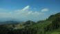 lush green hills with scattered trees and beautiful blue sky -best backpacking destinations in India
